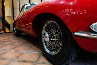 Close up of the wheel of a Red Jaguar E-Type